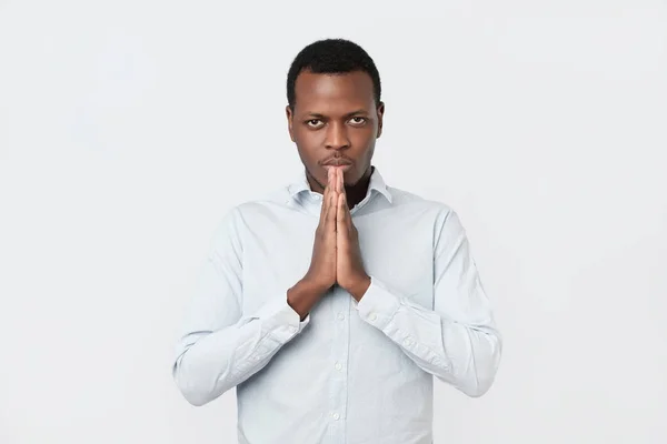Worried young african american man put hands together ask for help forgiveness in prayer — Stock Photo, Image