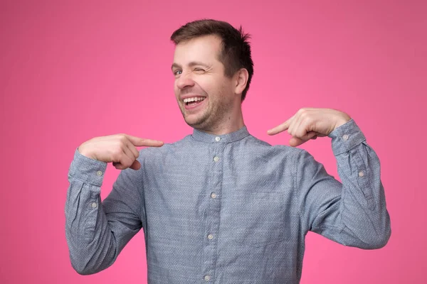 Hombre mirando confiado con sonrisa en la cara apuntando con los dedos a sí mismo — Foto de Stock