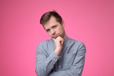 Genç beyaz adam tatmin olmamış ve yorgun görünüyor..