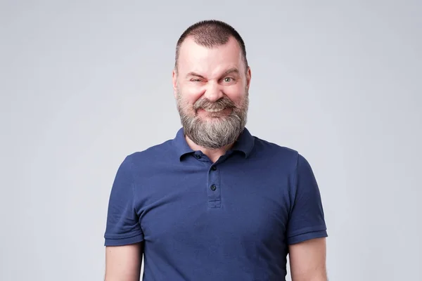 Mature male making a funny smiling grimace. Studio shot — Stock Photo, Image