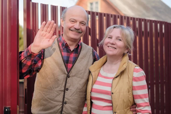 Mature parents meeting their children waving hands.