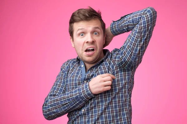 Caucasian, young man is worried and shocked because of sweating stain — Stock Photo, Image