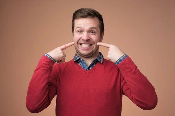 Young european man shows on his teeth. — 스톡 사진