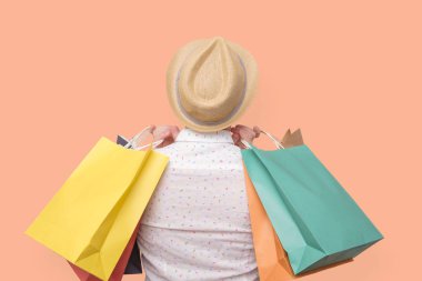 şapka adam kağıt paketleri tutan ve yukarı bakıyor.