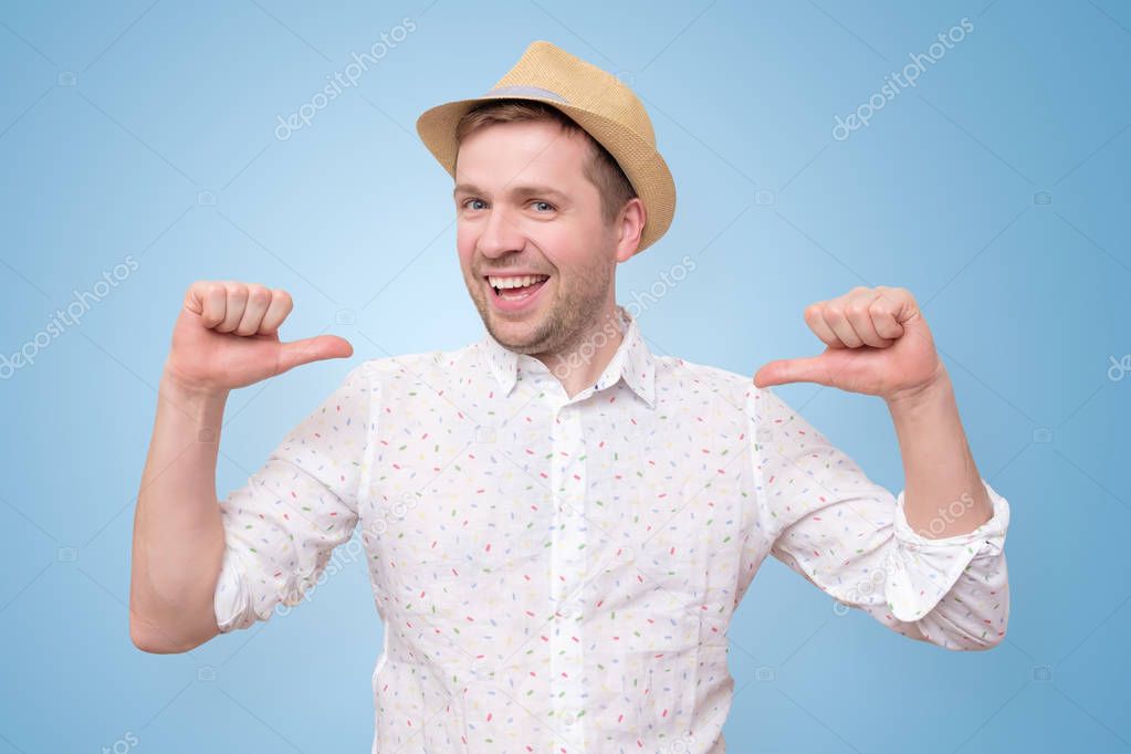 Man in summer hat looking confident with smile on face pointing on himself