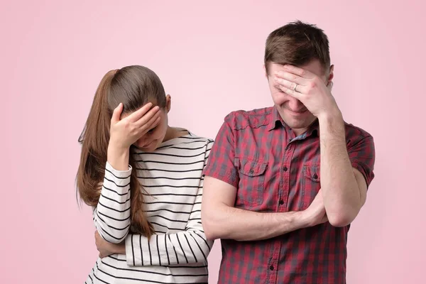 Young tired, fatigued couple with stressed face down with hands — Stock Photo, Image