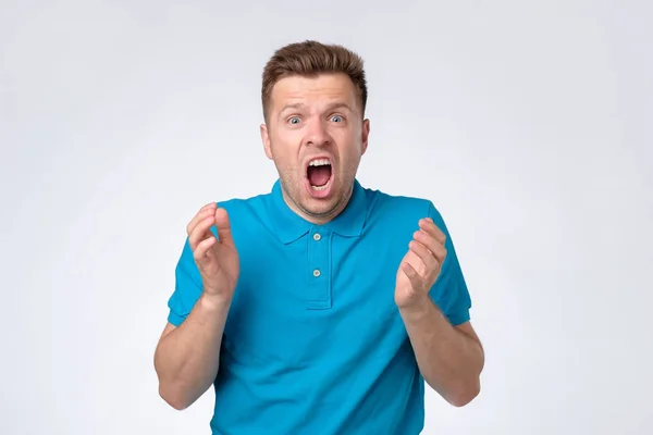 Молодий європейський хлопець у блакитній сорочці кричить — стокове фото