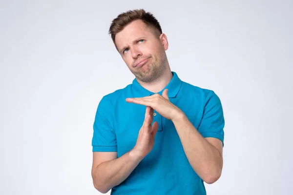 Man making time out gesture over grey background — Stock Photo, Image