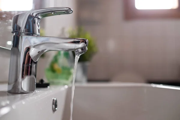 Open faucet washbasin with low water pressure — Stock Photo, Image