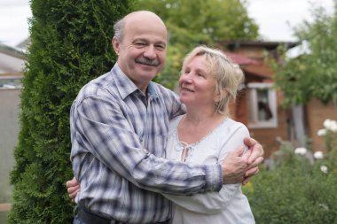 Yeşil yaz bahçesinde dinlenmek neşeli olgun çift