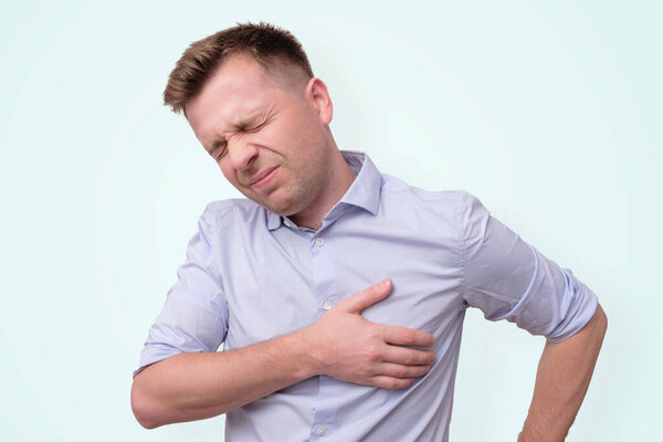 man feeling having heart attack symptom or breast cancer.