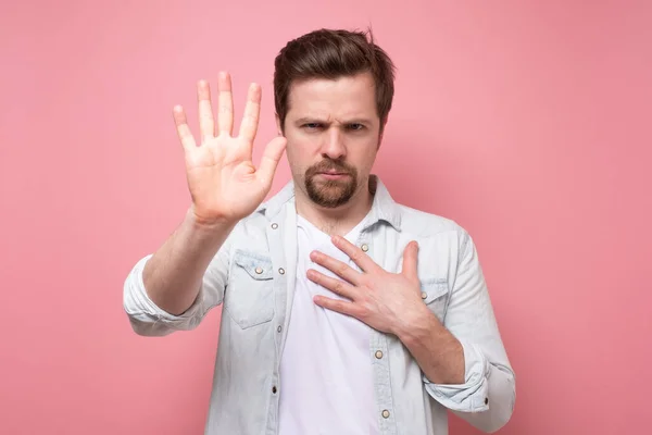 man holding out his hand to show stop gesture