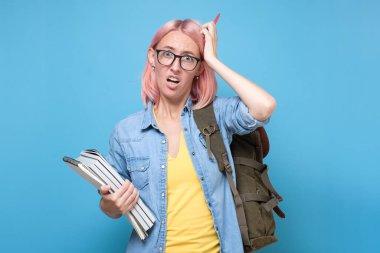 Young caucasian woman with glasses scratching head, thinking deeply about something clipart