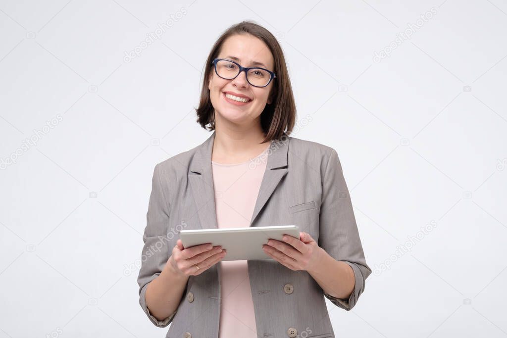 Portrait of a smiling businesswoman using a tablet computer.