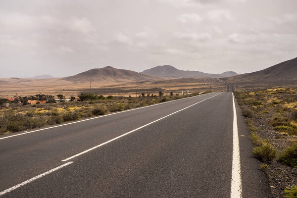 long way asphalt road in middle of mountains and valley peaks