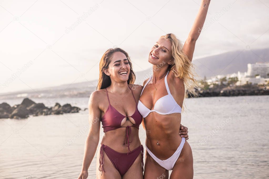 happy women friends having fun together at beach during summer vacation