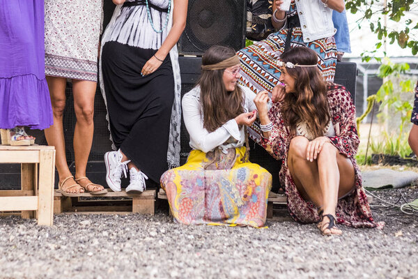  group of women in hippy clothes having party at daytime