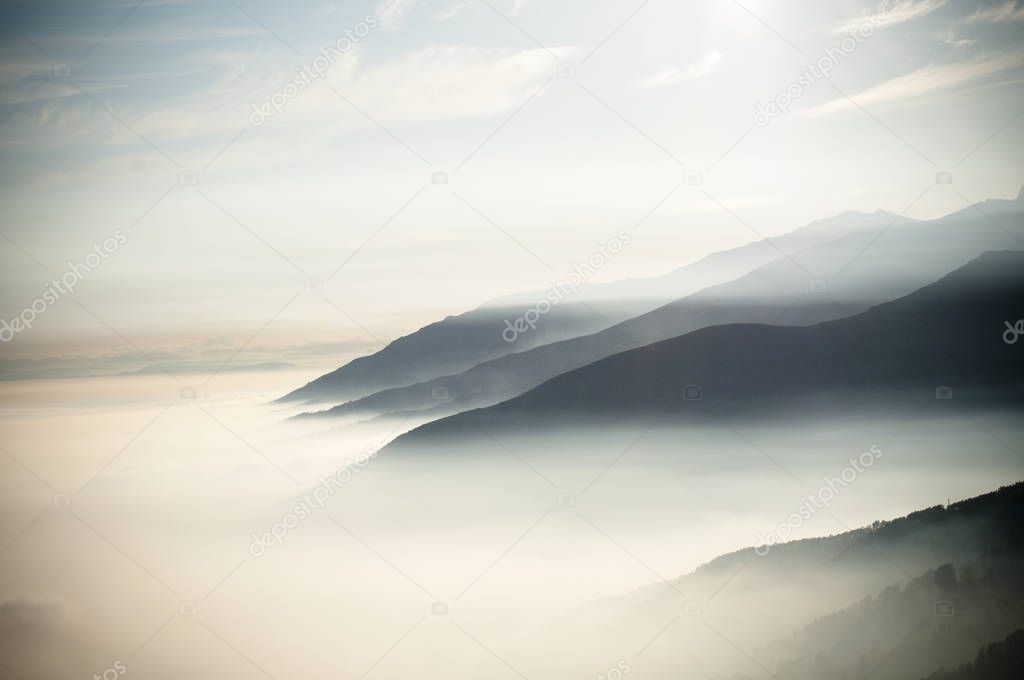 top of mountains with clouds like fog at early morning
