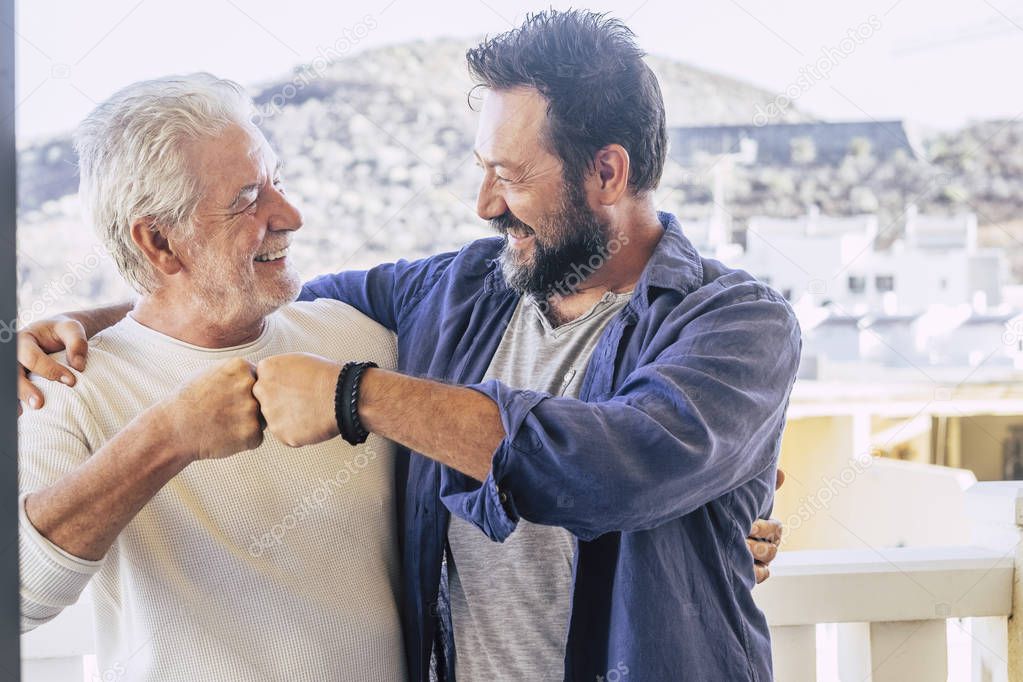 father and son having good time together and giving friendly punch each other