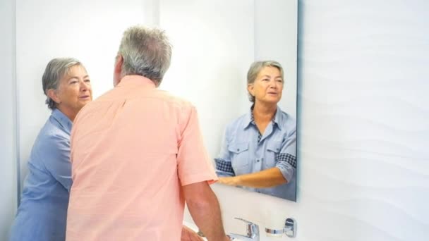 Senior Couple Kissing While Washing Hands Bathroom Home — Stock Video