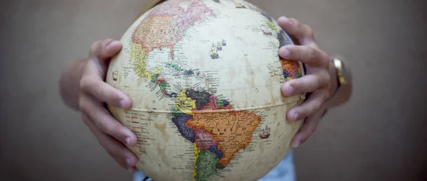 hands holding globe sphere, travel concept