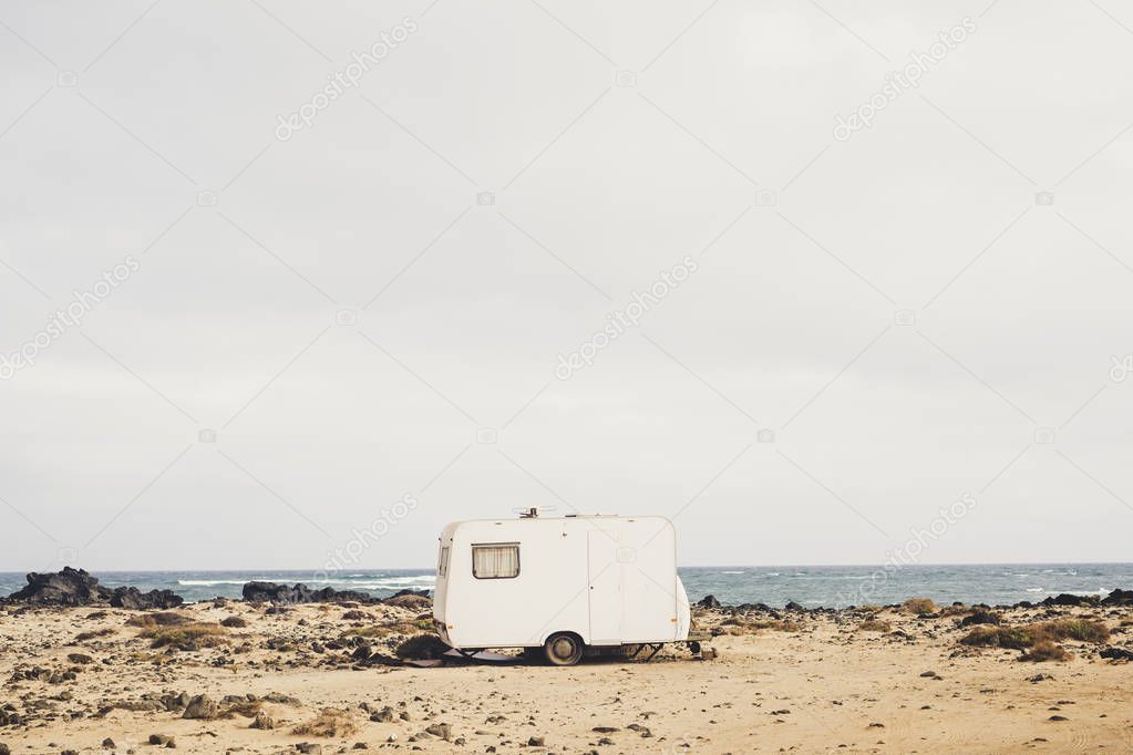 view of travel trailer on shore on ocean background