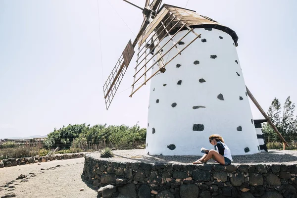 Woman Blonde Curly Hair Sitting Windmill Reading Booklet — Stock Photo, Image