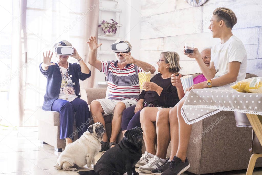 Family having fun and laughing while using virtual reality goggles headsets