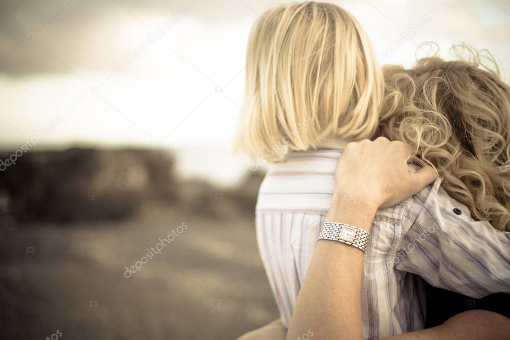 emotions and happiness for young blonde mother and little child son having fun and laughing together hugging outdoor and enjoying the nature and the time in family leisure activity