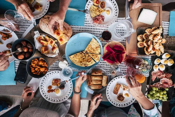 Top view of people hands taking food, dinner together