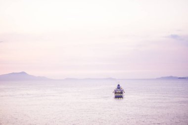 Pembe renkli günbatımı arka plan denizde yüzen turistik yolculuk tekne