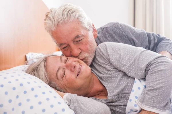 Happy Senior Couple Hugging Kissing While Lying Bed — Stock Photo, Image