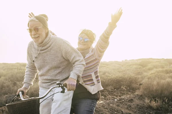 Aged Couple Laughing While Riding Bike Outdoor Leisure Activity — Stock Photo, Image