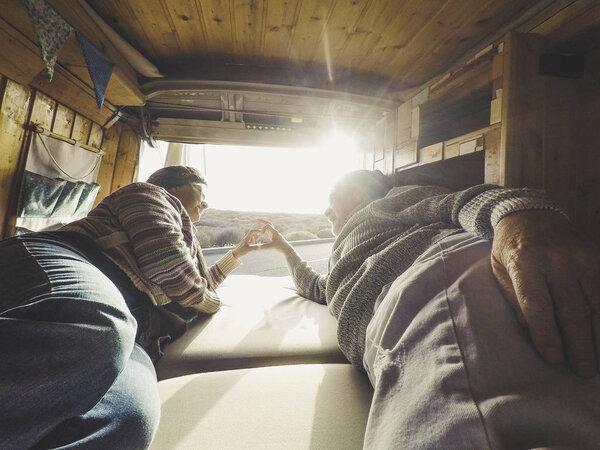 Adult Couple Lying Van Camper House Looking Sunset Stock Photo