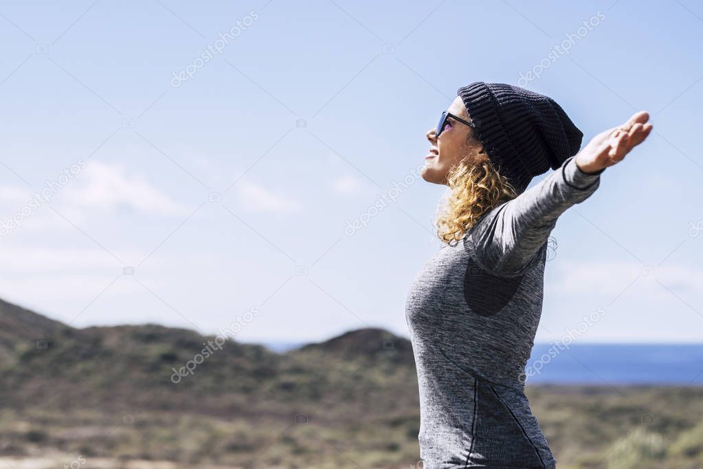 Happy woman with open arms enjoying freedom 