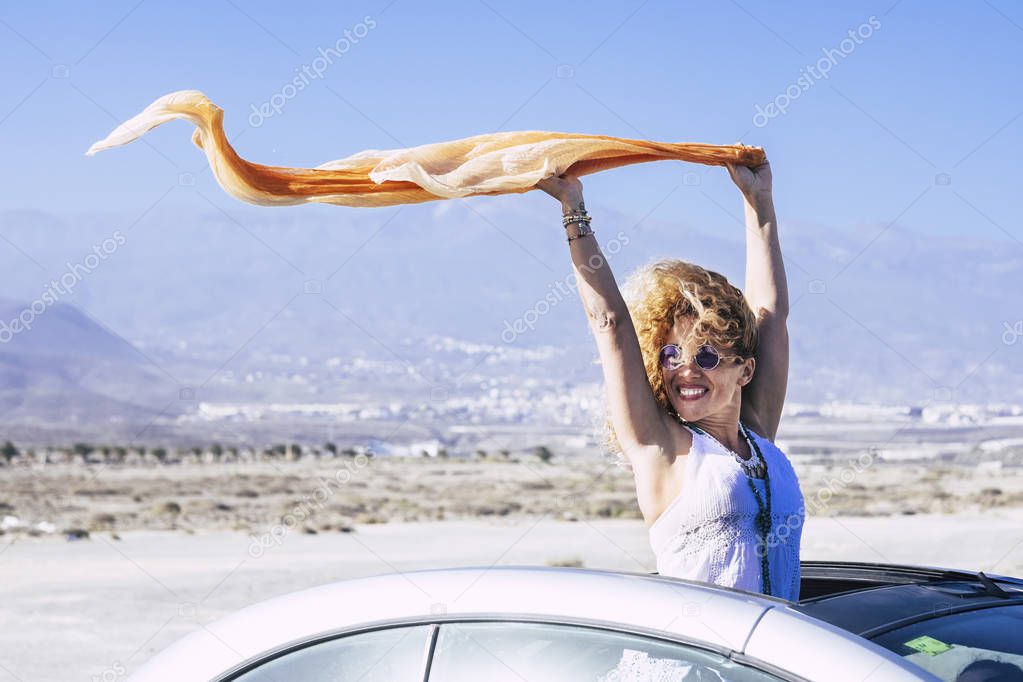 Cheerful beautiful young blonde woman travel by car 