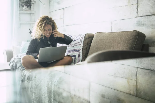 Curly Woman Gray Sweater Sitting Brown Sofa Blue Blankets Relaxes — Stock Photo, Image