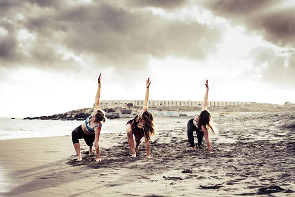 Pilates Posizione Equilibrio Tre Giovani Donne Attive Spiaggia Facendo Attività — Foto Stock