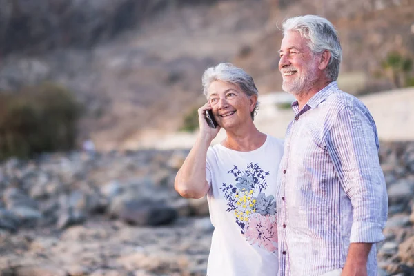 Happy Senior Couple Pebble Beach Laugh Joke Hugging Each Other — Stock Photo, Image
