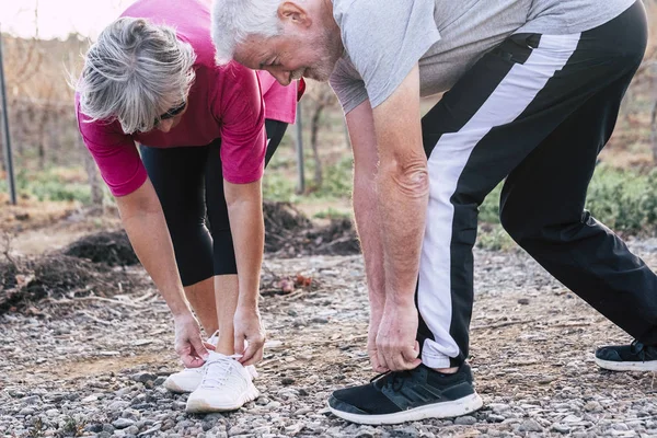 Elderly sport activity with adult white hair couple making sport outdoor