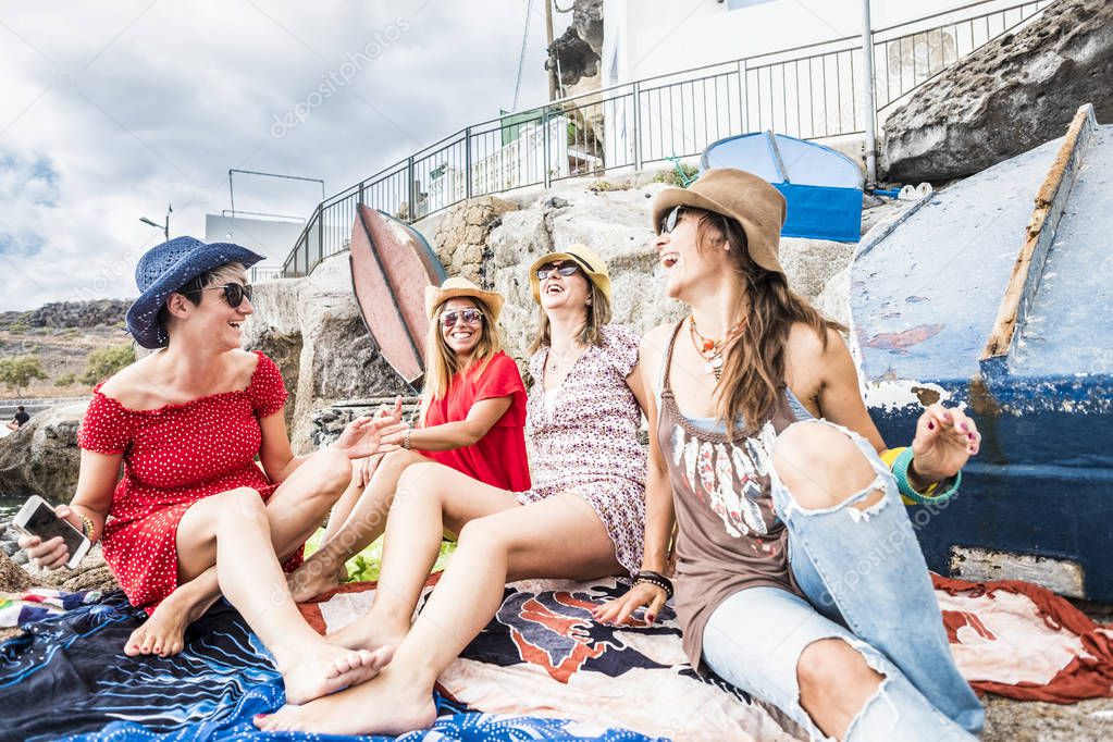 People in friendship outdoor leisure activity - group of beautiful cheerful women friends enjoy together the day on vacation - trendy fashion lifestyle for young ladies