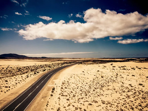 両側に砂漠と砂浜を持つ長い高速道路アスファルト道路 — ストック写真