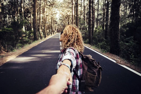 Happy traveler couple enjoying travel with backpack in outdoor nature forest