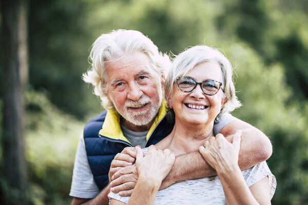 couple of cheerful happy senior people smiling and hugging in relationship