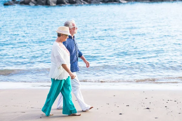 couple of people seniors walking at the beach