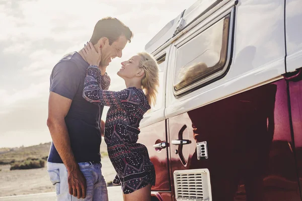 couple standing near vintage van and travel together