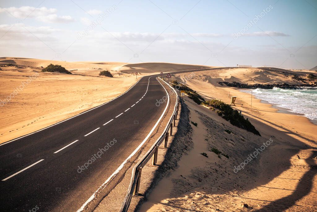 Long black asphalt road with desert and beach around for travel and adventure summer lifestyle concept with nobody traveling and no traffic cars