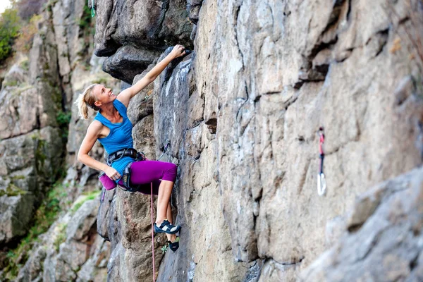 Kobieta wspina się na skale. — Zdjęcie stockowe