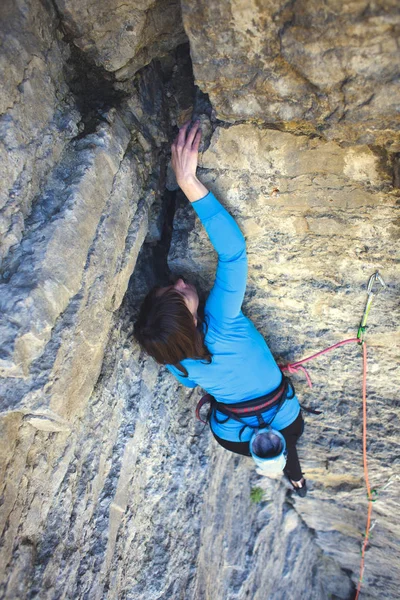 女の子は 岩を登っていきます 女性は克服困難な登山ルートです 岩に岩登り スポーツ アウトドアをやってください — ストック写真