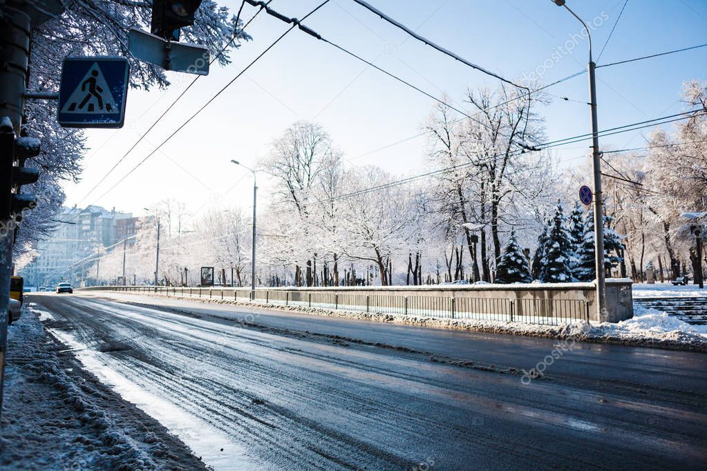 Winter city landscape. Street of a small town. Snow-covered pavement.